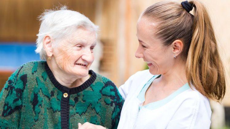 Elderly woman with carer