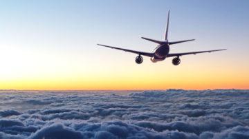 plane flying away in the sky