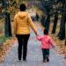 Child holding parents hands
