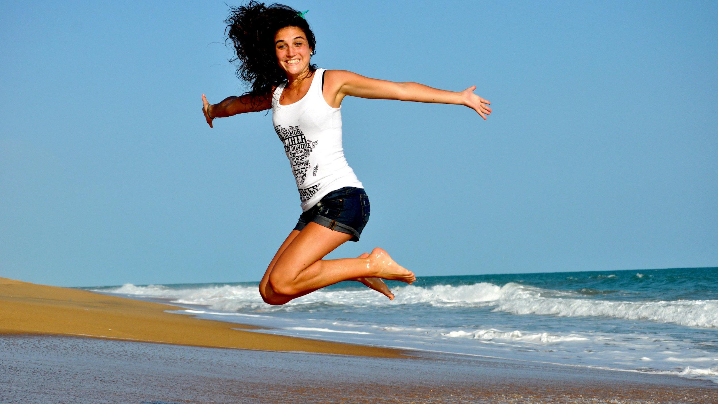 Woman girl beach jumping