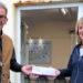 President William Tate receives his lateral flow test pack from the Welcome Teams Candy Osborne