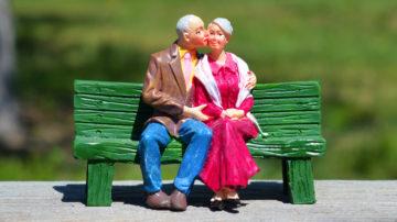 Old couple kissing on bench model