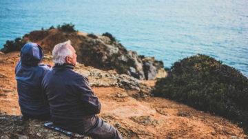 OLd couple looking out to sea