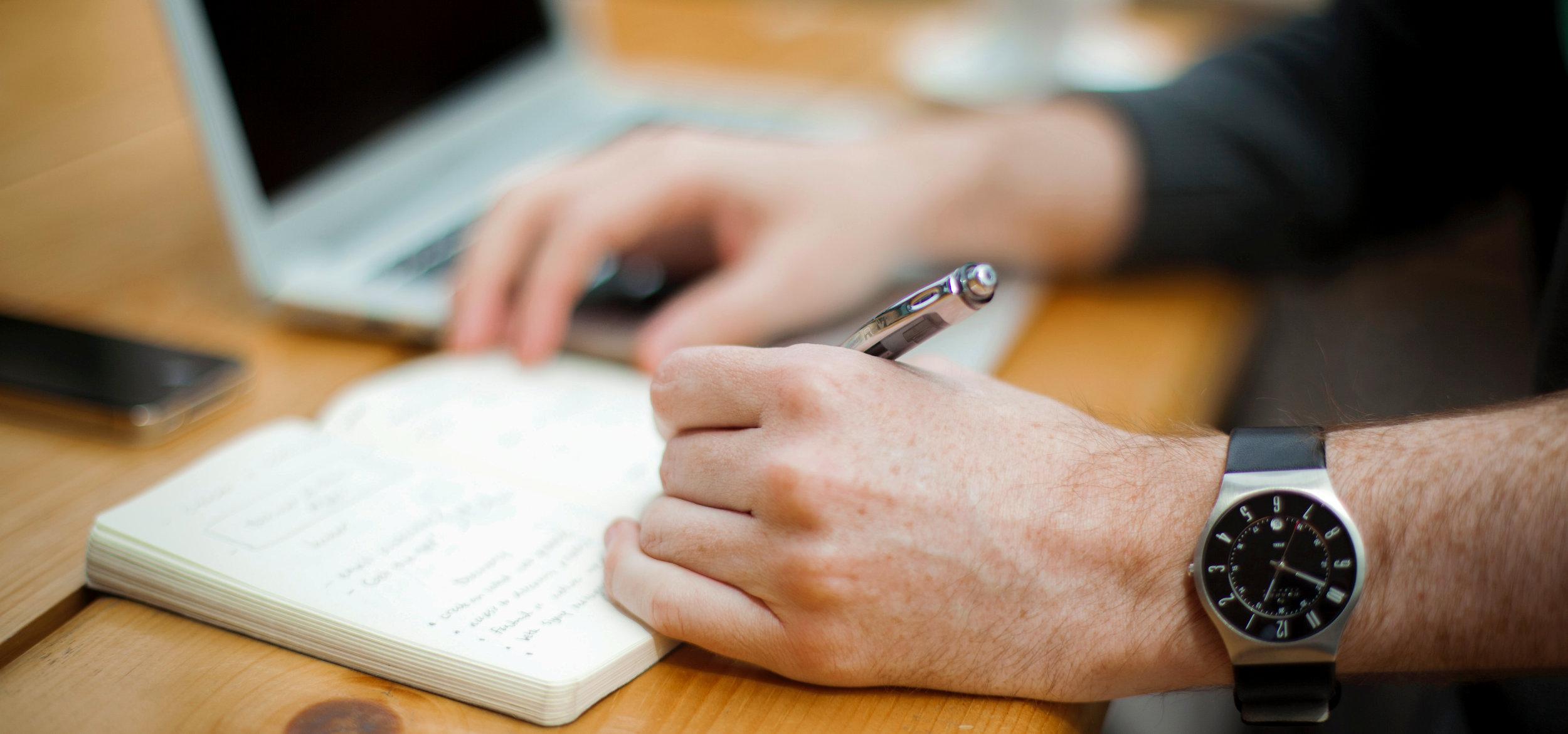 Office desk hands writing