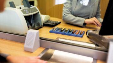 Clerk counting money cash coins bank