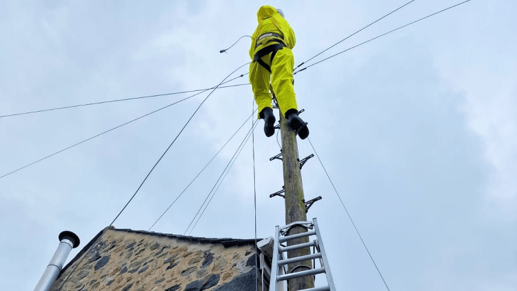 Sure engineer fixes an overhead cable after Storm Ciarán