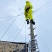 Sure engineer fixes an overhead cable after Storm Ciarán