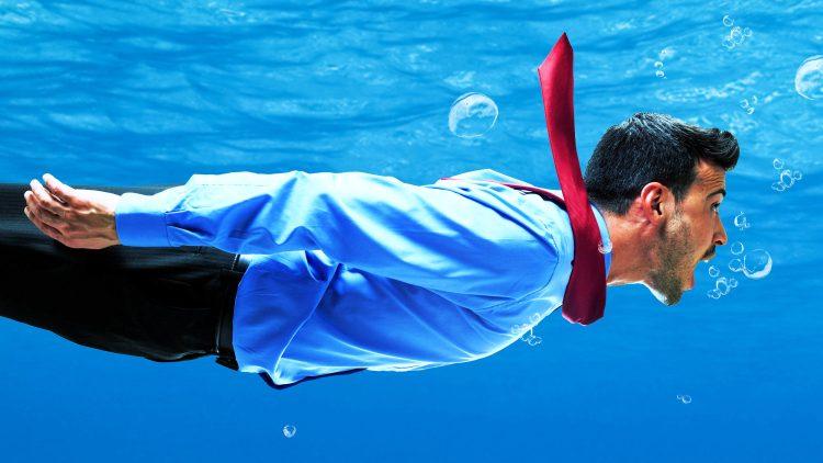 Man in business suit swimming