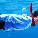 Man in business suit swimming