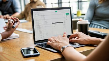 Woman checking her email in a meeting